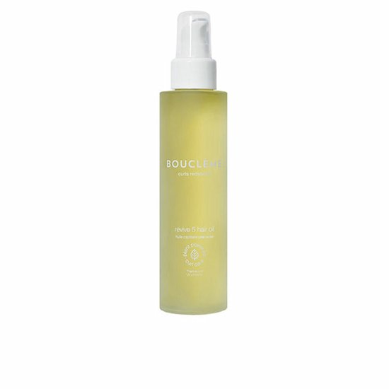 Gele fles met witte pomp, met het label 'BOUCLÈME curls redefined revive 5 hair oil'.