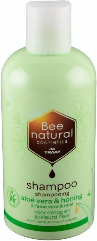 Lichtgroene fles shampoo met honing en aloë vera logo. Tekst: shampoo aloë vera & honing.