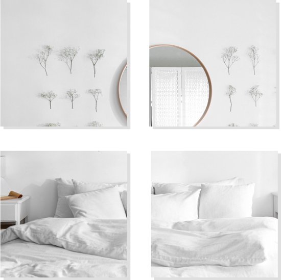 Een slaapkamerinterieur met witte lakens en een ronde spiegel aan de muur.
