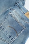 Close-up van de achterzak met het G-Star Raw logo op een lichtblauwe jeans.