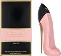 Roze pumpvormige parfumfles naast de verpakking 'Good Girl Carolina Herrera Blush'.