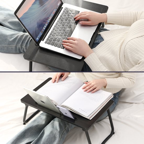 Zwart bedtafeltje met opgevouwen poten, met een laptop en een boek erop.