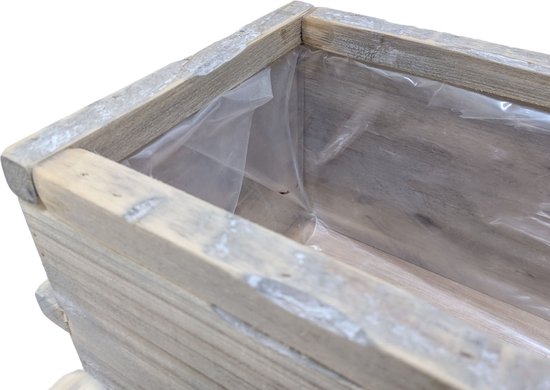 Detail van de rand van een rustieke houten plantenbak met plastic voering.