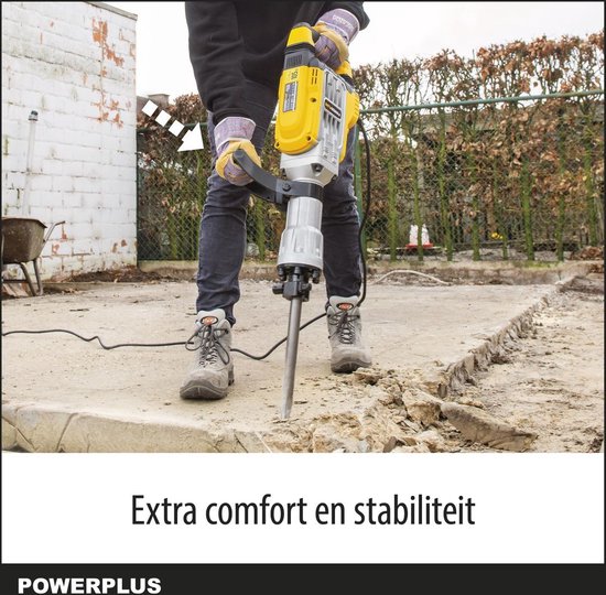 Persoon gebruikt gele breekhamer om beton te breken; extra comfort en stabiliteit.
