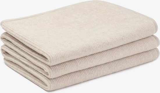Gevouwen crème wollen matrastopper met fijne ribbels, met beige randafwerking.