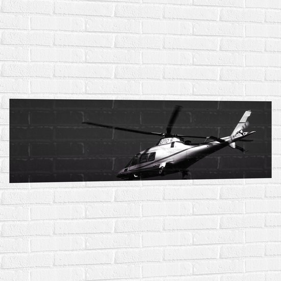 WallClassics - Muursticker - Vliegende Helikopter in Zwart Wit - 120x40 cm Foto op Muursticker