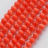 Perles de verre, yeux de chat ronds orange-rouge. Vendu par 2 brins d'environ 40 cm, un avec des perles de 6 mm et un avec des perles de 8 mm.