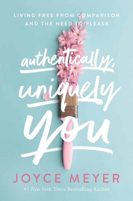 Boek met de titel 'Authentically, Uniquely You' met een penseel en roze bloesems op een blauwe achtergrond. Tekst: Living Free From Comparison and the Need to Please.