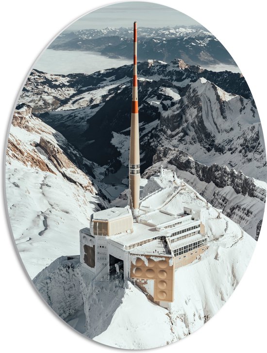 WallClassics - PVC Schuimplaat Ovaal - Santis - Mountain Peak Gebouw in Bergen - 42x56 cm Foto op Ovaal  (Met Ophangsysteem)