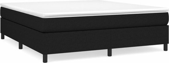 Zwart boxspringbed met een wit matras en vier zwarte pootjes.