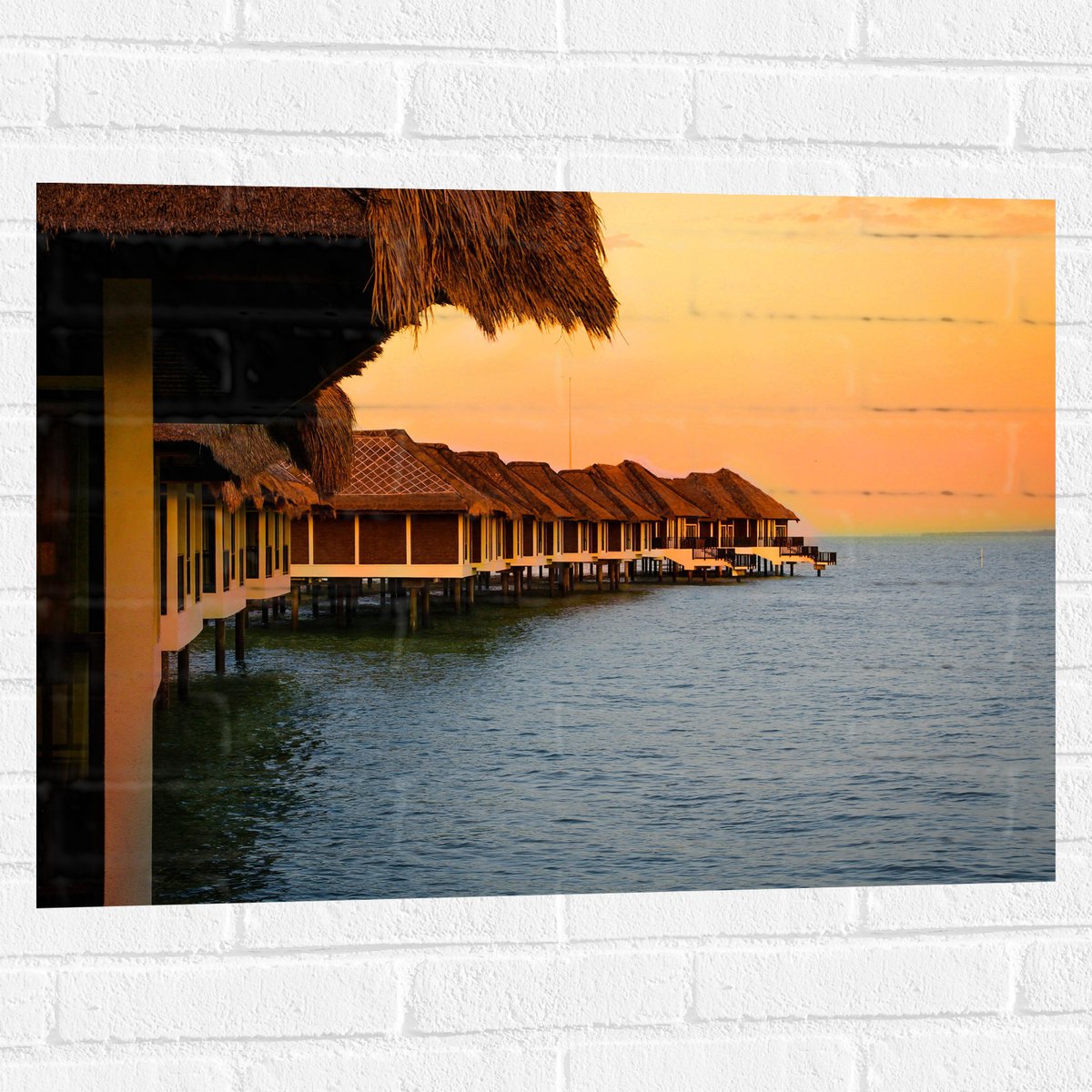 Muursticker - Huisjes op Palen in de Zee - 80x60 cm Foto op Muursticker