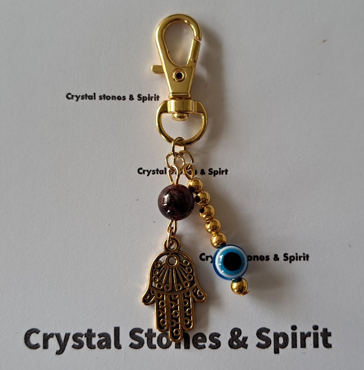 Boze Oog / Khamsa met "Granaat" , sleutelhanger goudkleurig