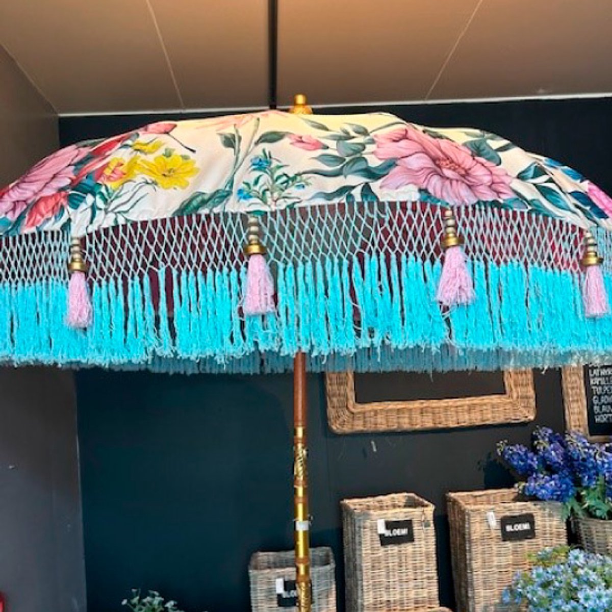 Colorful floral patterned Bali parasol with white fabric and pink fringes, diameter 185 cm.