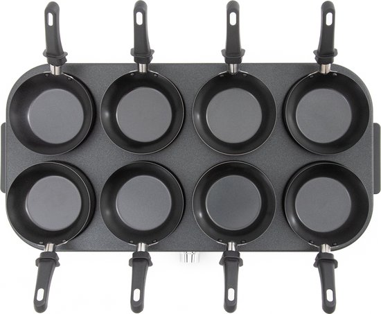 Bovenaanzicht van een zwart gourmetstel met 8 lege wokpannetjes.