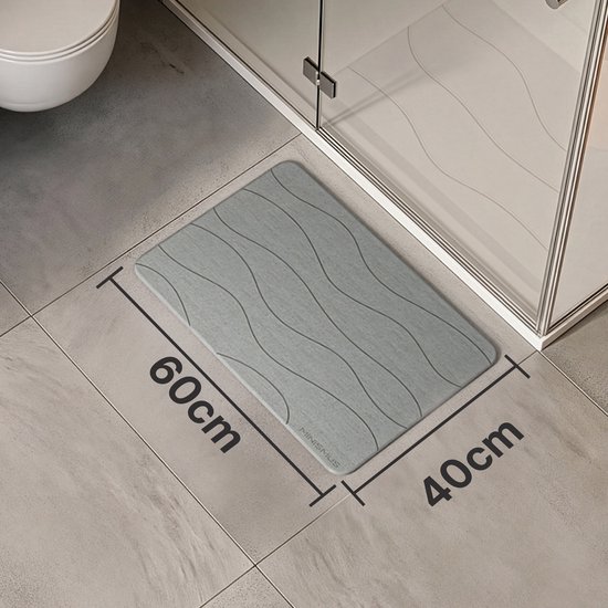 Tapis de bain gris de 60x40cm à motif ondulé, à côté d'une cabine de douche.
