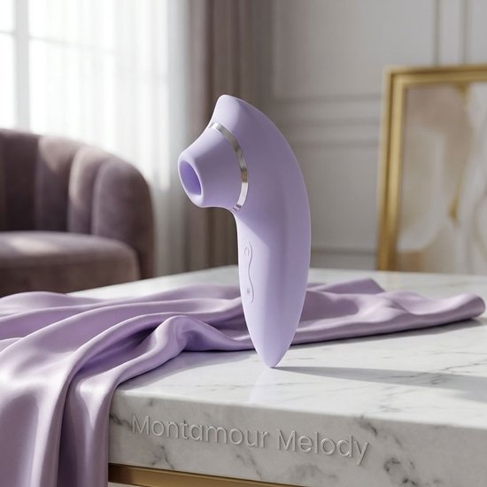 Lila Montamour Melody luchtdruk vibrator op een marmeren tafel met paarse stof.
