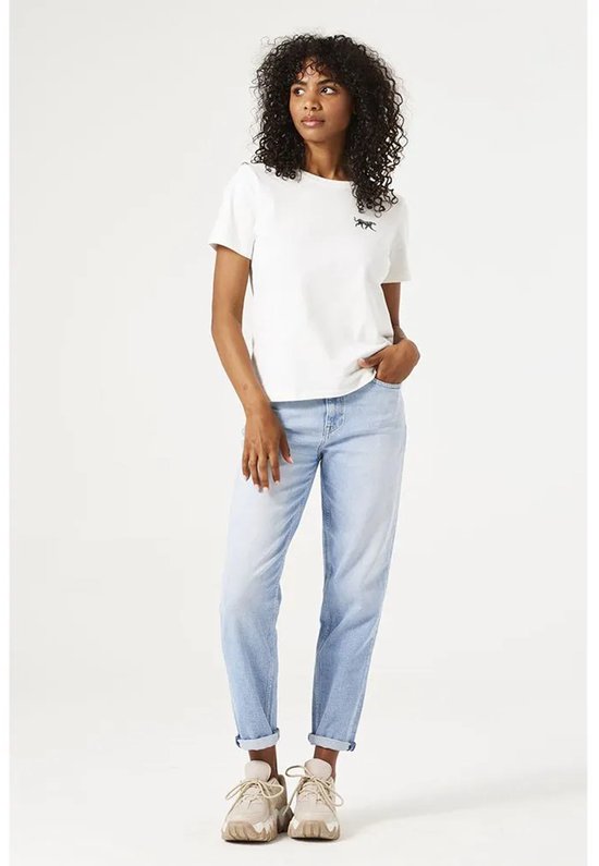 Model draagt een witte T-shirt met zwarte panterprint en een lichtblauwe mom fit jeans.