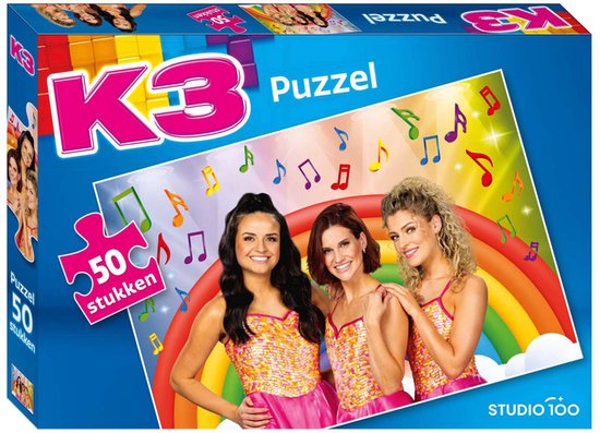 Puzzle K3 50 pièces : trois filles chantant portant des tops à paillettes et des robes roses devant un arc-en-ciel avec des notes de musique.