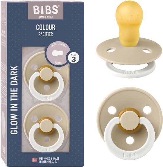 Verpakking met twee BIBS Colour Glow spenen in beige en wit. De spenen zijn maat 3 (18+ maanden), rond en glow-in-the-dark.