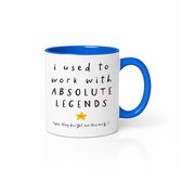 Witte mok met blauwe binnenkant en handvat. Tekst: 'i used to work with ABSOLUTE LEGENDS' met gele ster en tekst ' (yes, they bought me this mug.)'