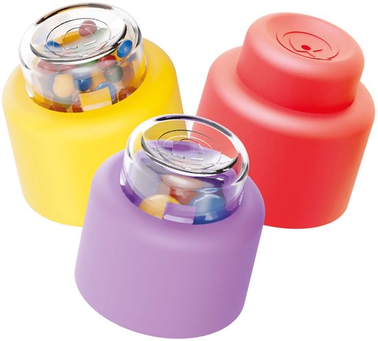 Drie zachte, ronde bouwblokken: geel, paars en rood. De gele en paarse blokken hebben een transparante dop gevuld met gekleurde balletjes.