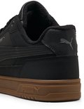 Zwarte Puma sneaker, achterkant zichtbaar met bruine zool en Puma logo.