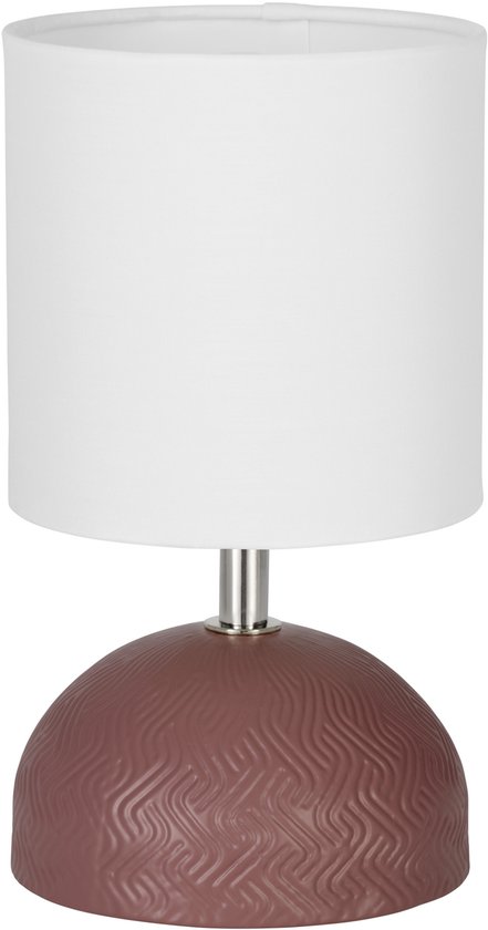 Lampe de table rose avec abat-jour blanc et relief sur le pied rond.