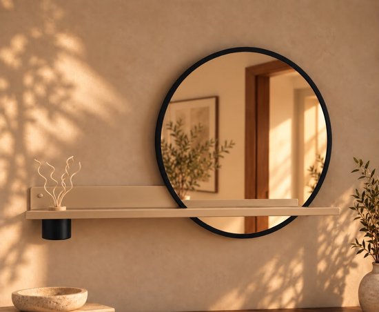 Beige wandplank met zwarte ronde spiegel en diffuser in een warm verlichte badkamer.