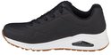 Zwarte Skechers Uno dames sneaker met witte zool en bruin accent op de zool.