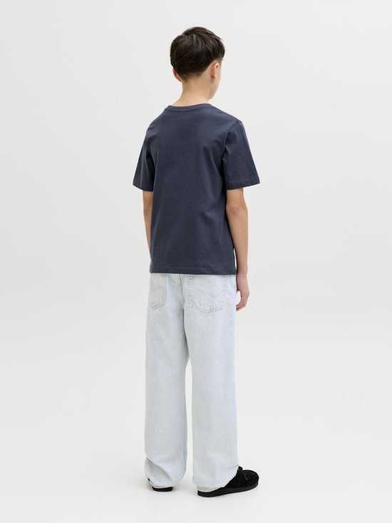 Achterkant van een jongens T-shirt in donkerblauw met 'JACK & JONES' print, met een lichte jeans.