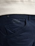 Sluiting van een donkerblauwe cargobroek met zakdetail en tekst: 'DENIM DRIVEN PETROL IND. DIV.4148-U.S.'.