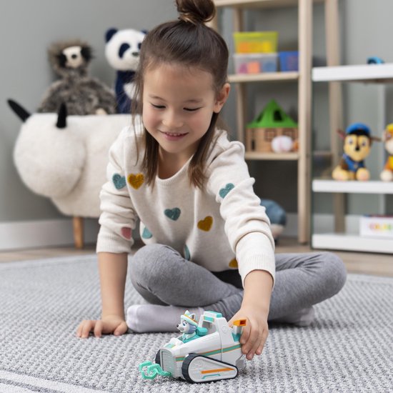 Meisje speelt met de Everest sneeuwschuiver speelgoedauto met Paw Patrol figuur Everest.