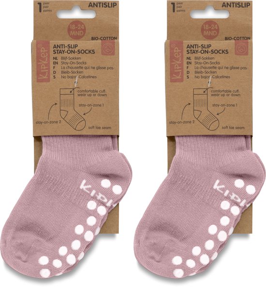 Paar roze KipKep stay-on-sokken, maat 18-24 maanden, met witte antislip nopjes en deels verpakking.