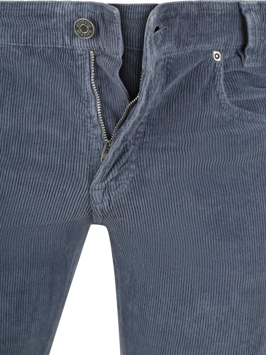 Gedetailleerde ritssluiting van een blauwe corduroy broek.