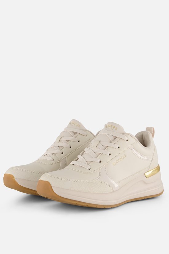 Paar crèmekleurige lage sneakers van Skechers met gouden accenten op de zijkant en slangenprint details. Gummi zolen.