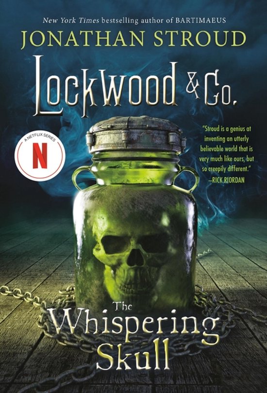 Boekcover van "Lockwood & Co. The Whispering Skull" met een glazen pot met een schedel erin, kettingen en rook.