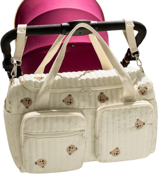 Sac à langer crème avec des ours, attaché à une poussette.