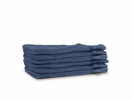 Pile de gants de toilette bleu foncé avec une texture côtelée.