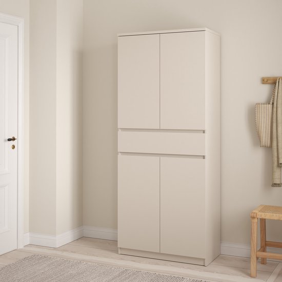 Taupe schoenenkast in een hal, met een gesloten boven- en onderkant, gescheiden door een lade.