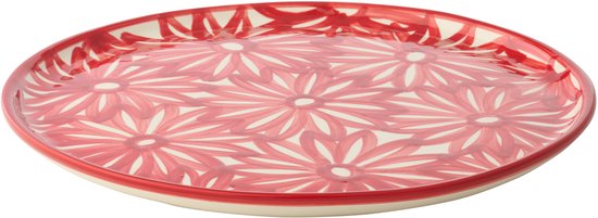 Assiette en céramique rouge avec motif floral blanc et bordure rouge.