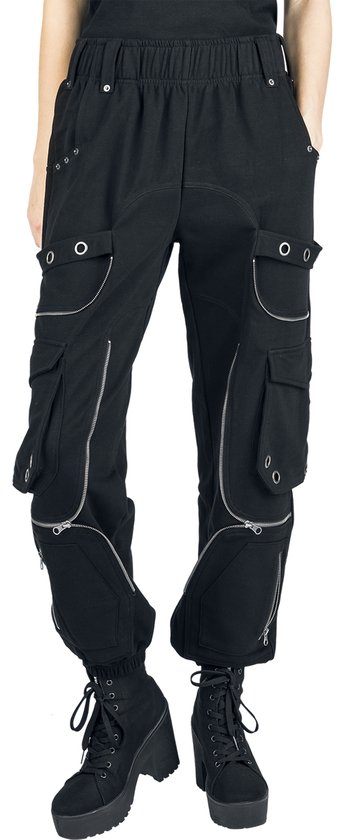 Model in zwarte cargo broek met ritsen, oogjes en elastische tailleband, met platform laarzen.