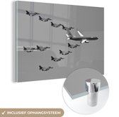 MuchoWow® Glasschilderij 150x100 cm - Schilderij acrylglas - Personenvliegtuig met escorte van straaljagers - zwart wit - Foto op glas - Schilderijen