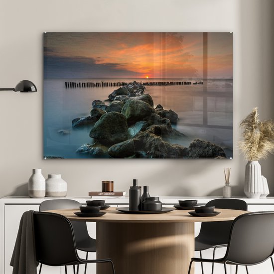 MuchoWow® Glasschilderij 120x80 cm - Schilderij acrylglas - Zee - Zon - Stenen - Foto op glas - Muurdecoratie woonkamer - Wanddecoratie slaapkamer - Schilderijen