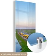 MuchoWow® Glasschilderij 60x120 cm - Schilderij acrylglas - Een trein rijdt door een landschap - Foto op glas - Schilderijen