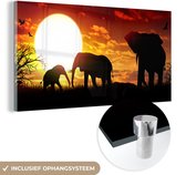 MuchoWow® Glasschilderij 40x20 cm - Schilderij acrylglas - Een illustratie van olifanten bij een zonsondergang - Foto op glas - Schilderijen