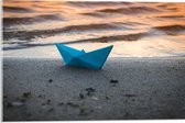 Acrylglas - Blauwe Papieren Origami Bootje Aangespoeld op het Strand tijdens Opkomende Zon - 60x40 cm Foto op Acrylglas (Met Ophangsysteem)