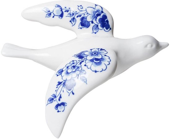 Wit porseleinen vogel met Delftsblauwe bloemenpatronen op vleugels en staart.