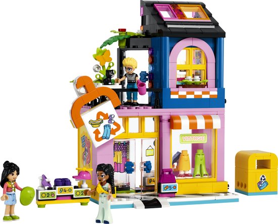Magasin de vêtements vintage LEGO Friends avec figurines et une poubelle jaune.