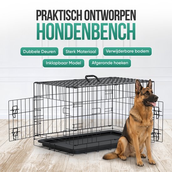 Zwarte metalen hondenbench met een Duitse herder ernaast.