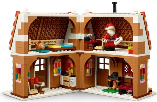 Open LEGO winters peperkoekhuis met slaap-, woon- en keukengedeelte. Kerstman minifiguur in de keuken.
